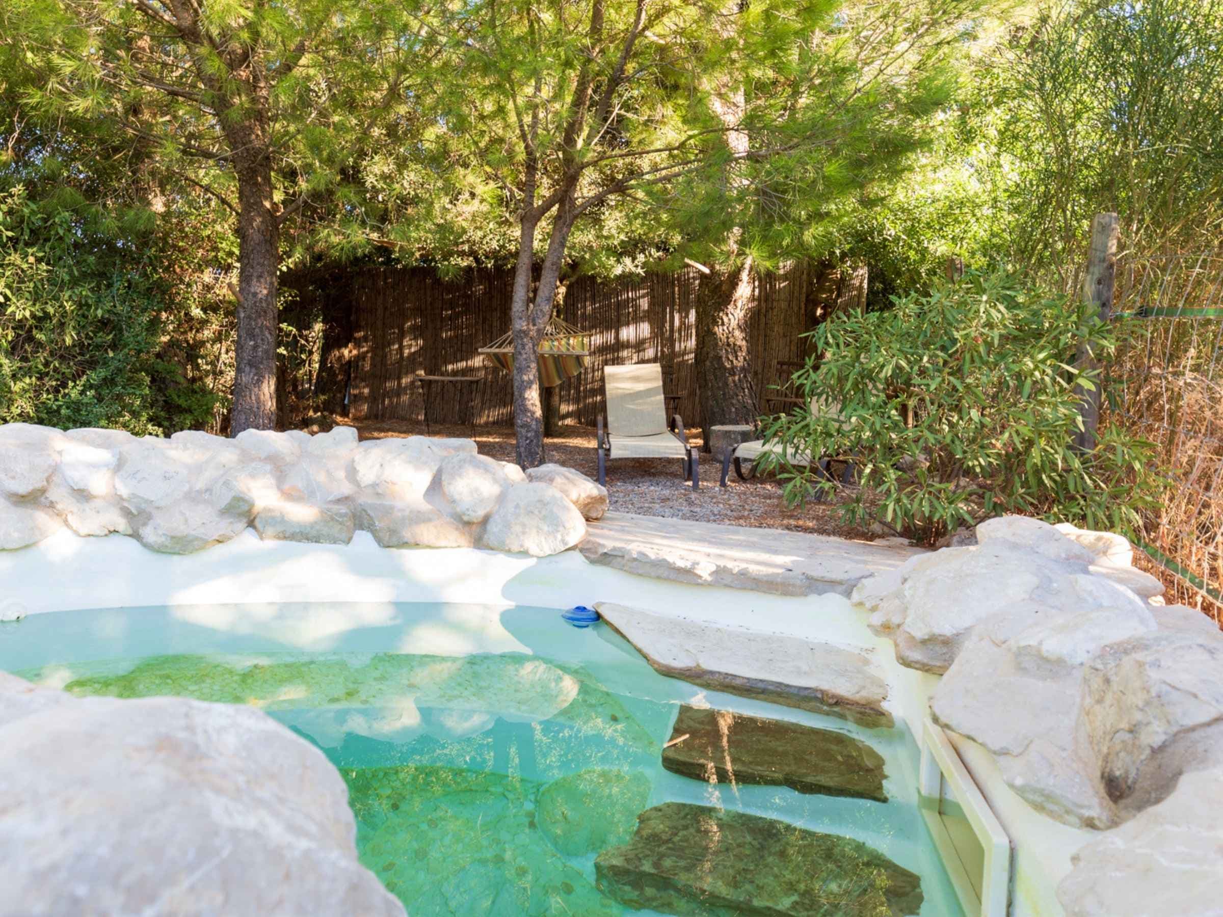 Rockpool with sun loungers and hammock.